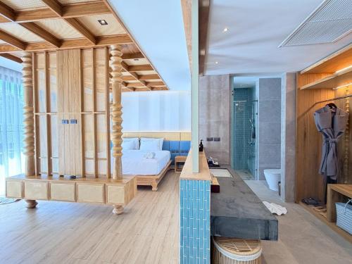 A master bedroom with a bed and a bathroom at Ananya Lipe Resort in Koh Lipe