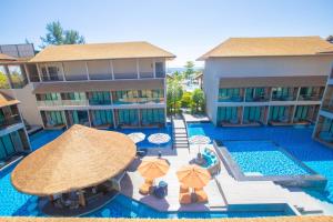 An overhead view of a pool with umbrellas and chairs at Ananya Lipe Resort in Koh Lipe