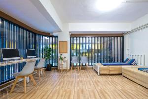 a living room with a couch and a table at BED Friends Poshtel in Chiang Rai