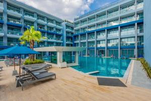 A large building with a swimming pool in front of it at BlueSotel SMART Krabi Aonang Beach - Adults only