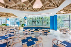 A dining room with tables and chairs and a stained glass window at BlueSotel SMART Krabi Aonang Beach - Adults only