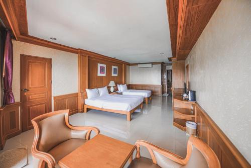 Room with two beds and a table and chairs