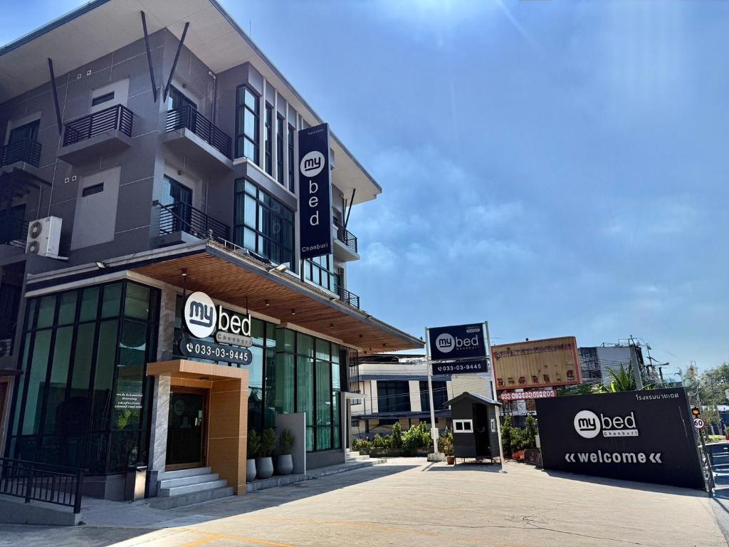 a building with signs on the side of it at Mybed Chonburi in Ban Nong Tako