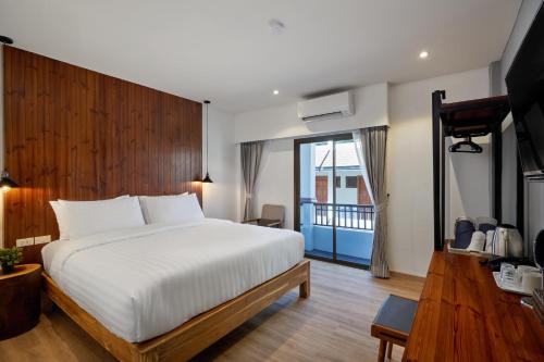 A bedroom with a large white bed and a window at P2 Wood Loft in Phi Phi Islands