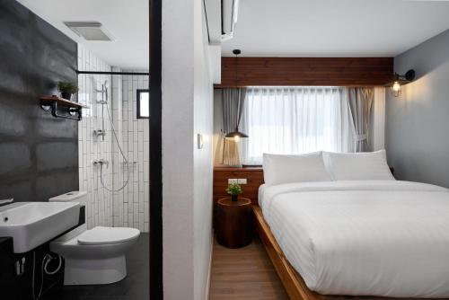 A bedroom with a bed and a bathroom at P2 Wood Loft in Phi Phi Islands