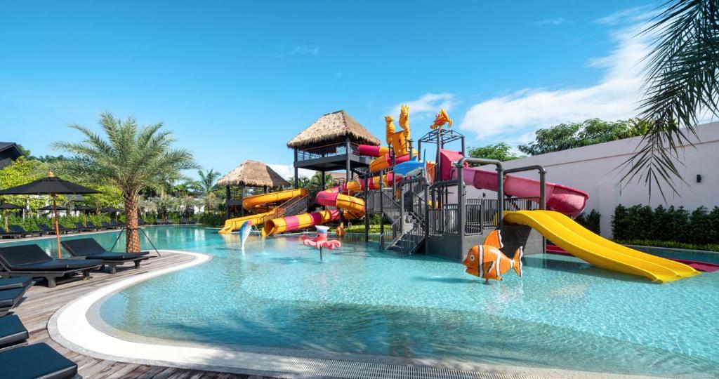A pool with a water slide in a resort at The Splash Koh Chang in Koh Chang