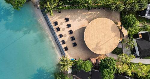 An aerial view of a pool with a group of chairs at The Splash Koh Chang in Koh Chang