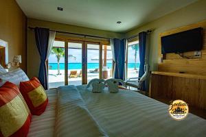 a bedroom with a bed with a view of the ocean at Zodiac Seesun Resort in Koh Lipe