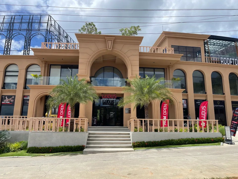 Ludus Sports Complex, an arched three-storey building on Soi Taied
